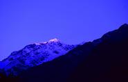 first ray of sun on manali snow peaks