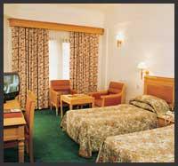 view of the bed room in Abad airport Hotel Cochin